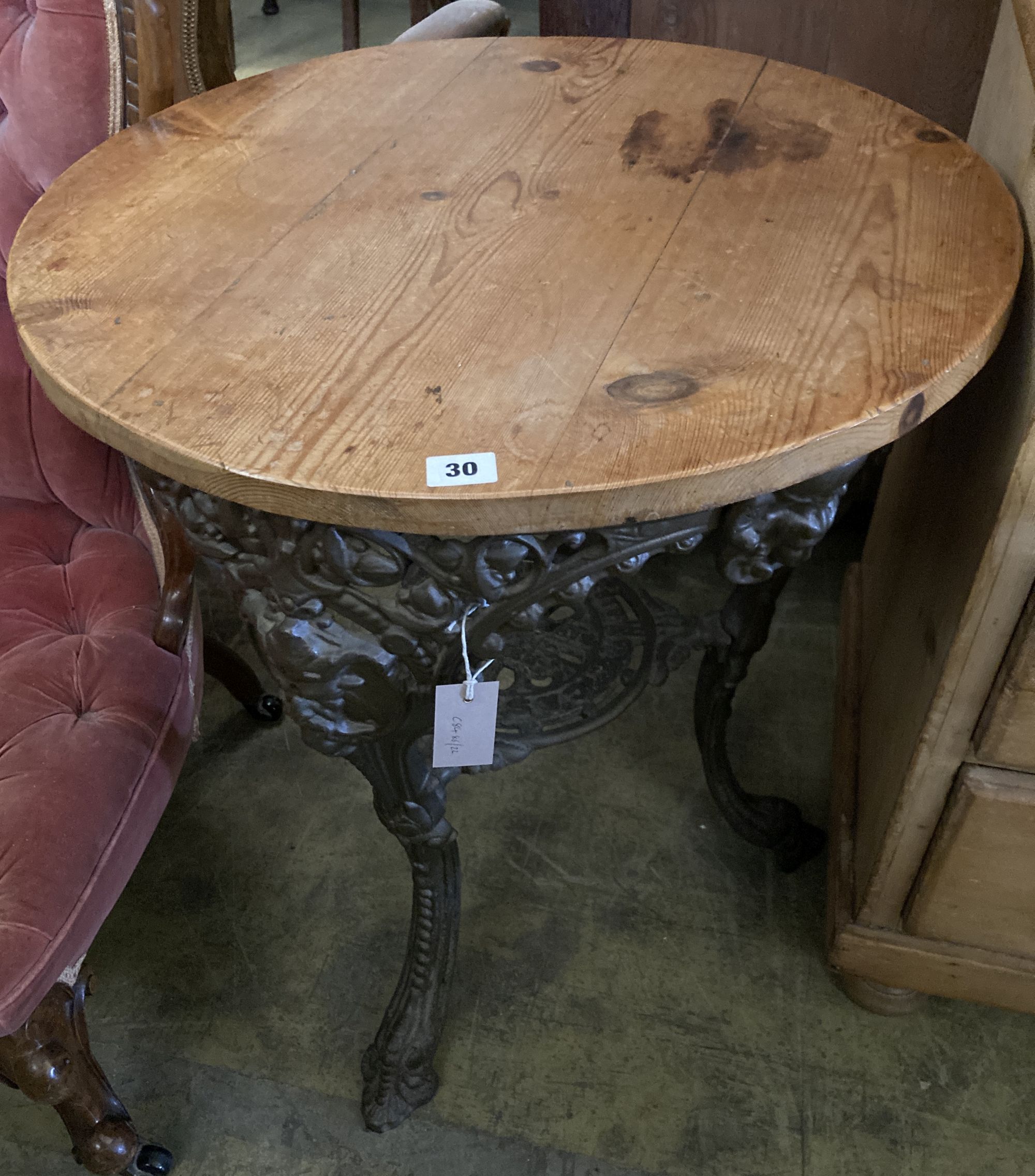 A Victorian cast iron pine top tavern table, 67cm diameter, height 72cm